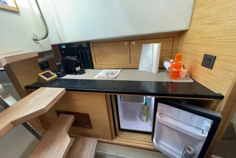 Slide: The Image of Interior of 2021 De Antonio Yachts Center Console with kitchenette and mini fridge. - 22