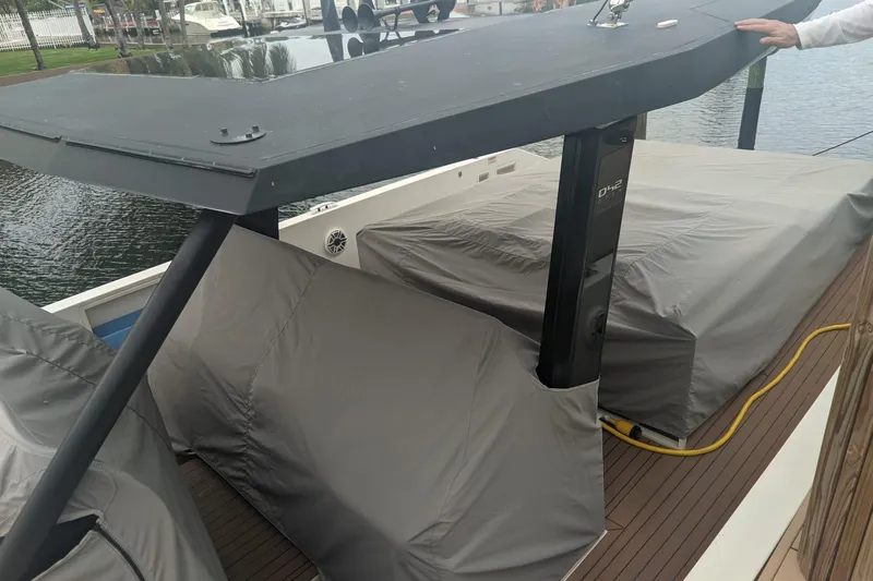 Slide: The Image of 2021 De Antonio Yachts Center Console with covered deck, docked by the water. - 23