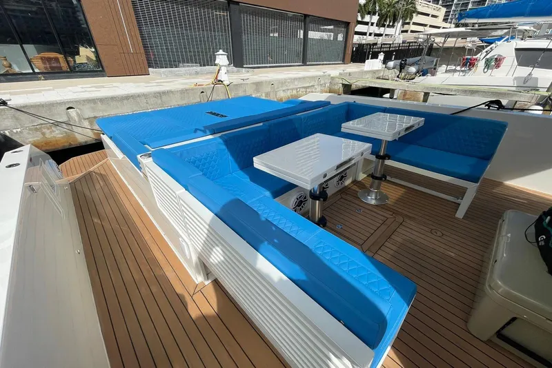 Slide: The Image of 2021 De Antonio Yachts Center Console with blue seating and wooden deck. - 3