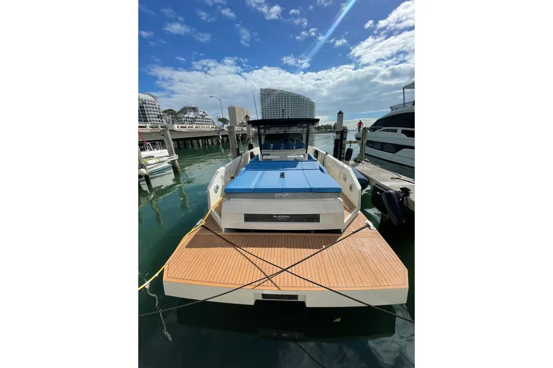 Slide: The Image of 2021 De Antonio Yachts Center Console docked at marina under blue sky. - 5