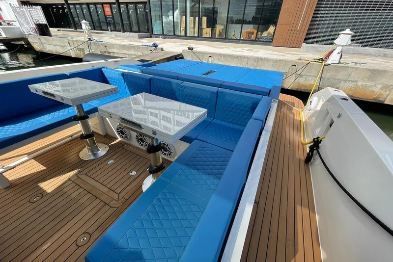Slide: The Image of 2021 De Antonio Yachts Center Console with blue seating and wooden deck. - 6