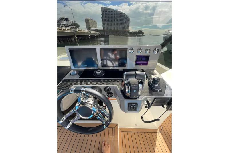 Slide: The Image of 2021 De Antonio Yachts Center Console helm with modern controls and dual screens. - 8