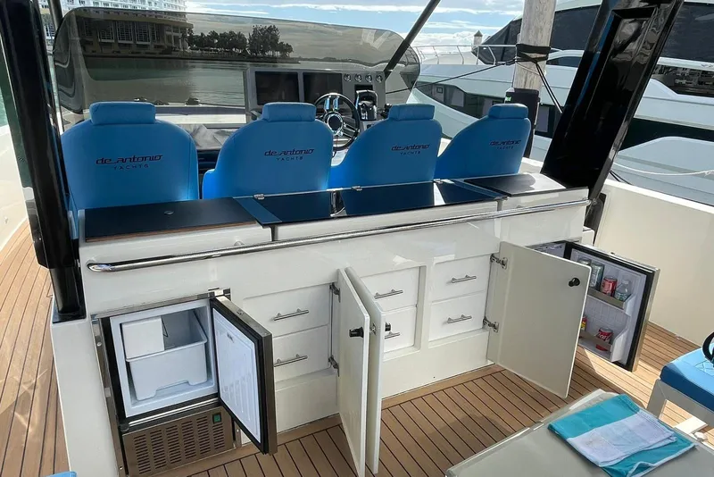 Slide: The Image of 2021 De Antonio Yachts Center Console with open storage and seating, docked at marina. - 9