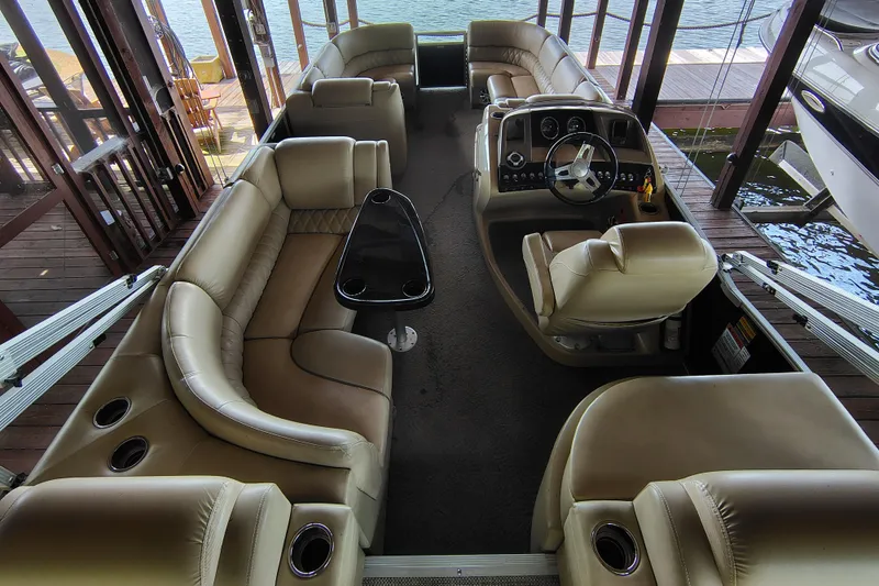 Slide: The Image of 2014 Bennington 2575 QCW I/O pontoon boat interior with luxurious seating and helm. - 12