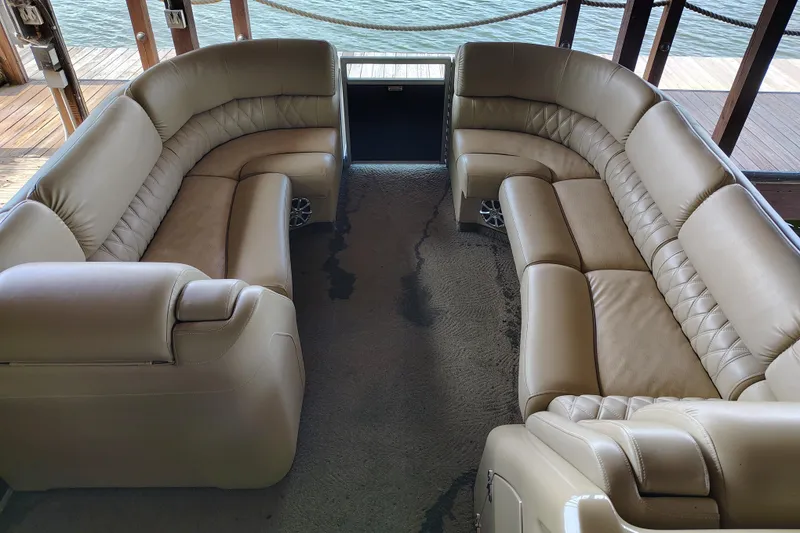 Slide: The Image of Luxurious seating on a 2014 Bennington 2575 QCW I/O boat, docked by the water. - 14