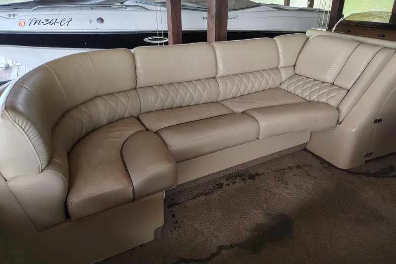Slide: The Image of 2014 Bennington 2575 QCW I/O boat interior with beige leather seating. - 16