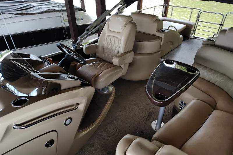 Slide: The Image of Luxurious interior of a 2014 Bennington 2575 QCW I/O boat with plush seating and steering console. - 18