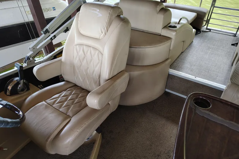 Slide: The Image of Luxurious interior of a 2014 Bennington 2575 QCW I/O boat with plush seating. - 20