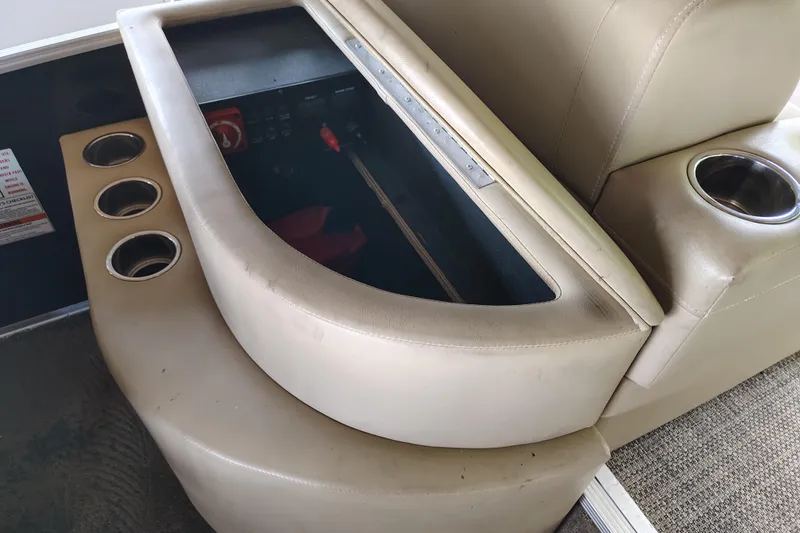 Slide: The Image of 2014 Bennington 2575 QCW I/O boat interior with cup holders and storage compartment. - 22