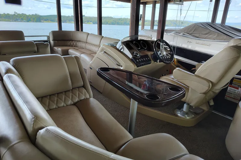 Slide: The Image of Interior of 2014 Bennington 2575 QCW I/O boat with luxurious seating and steering console. - 26