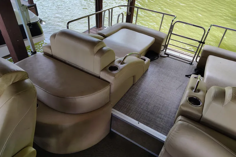 Slide: The Image of Interior of 2014 Bennington 2575 QCW I/O boat with beige seating and cup holders. - 27