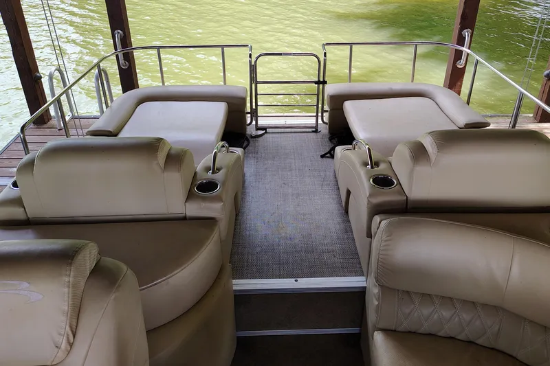 Slide: The Image of Interior of 2014 Bennington 2575 QCW I/O boat with beige seating and cup holders. - 28