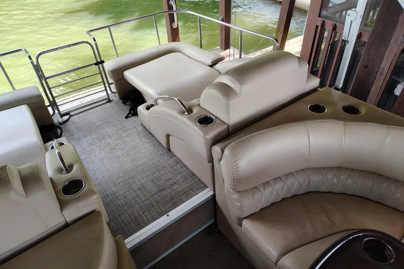 Slide: The Image of Luxurious interior of 2014 Bennington 2575 QCW I/O pontoon boat with plush seating and cup holders. - 29