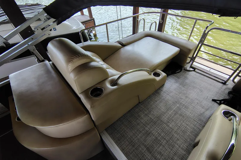 Slide: The Image of Luxurious seating area on a 2014 Bennington 2575 QCW I/O boat with beige upholstery. - 31