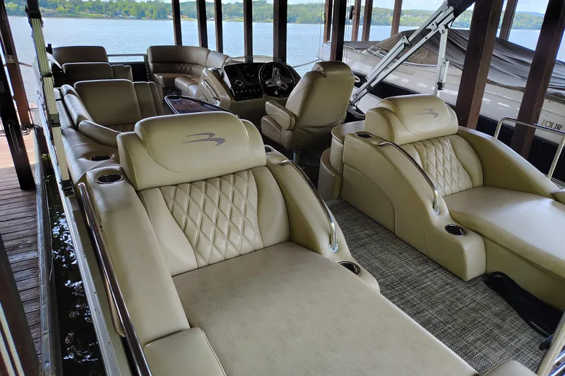 Slide: The Image of 2014 Bennington 2575 QCW I/O boat interior with luxurious beige seating and lake view. - 35