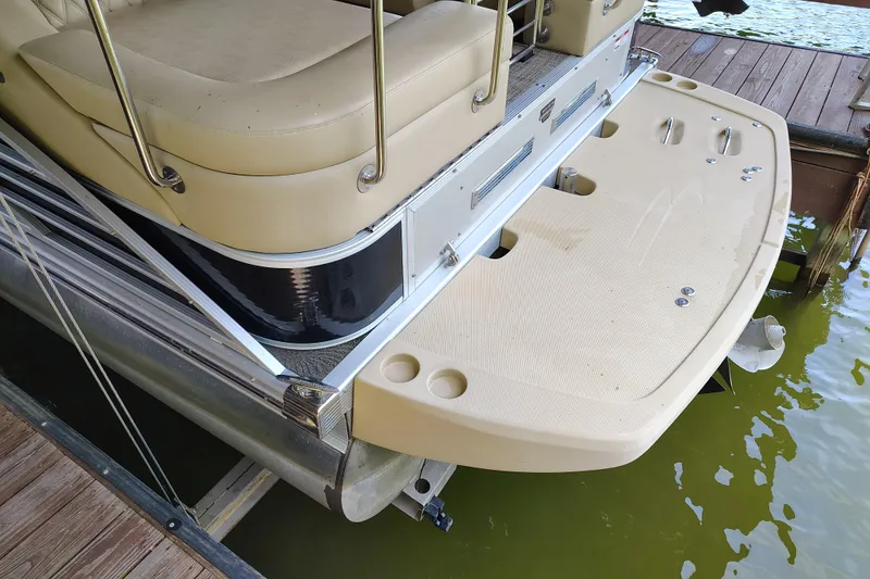 Slide: The Image of 2014 Bennington 2575 QCW I/O boat with beige seating and swim platform. - 42
