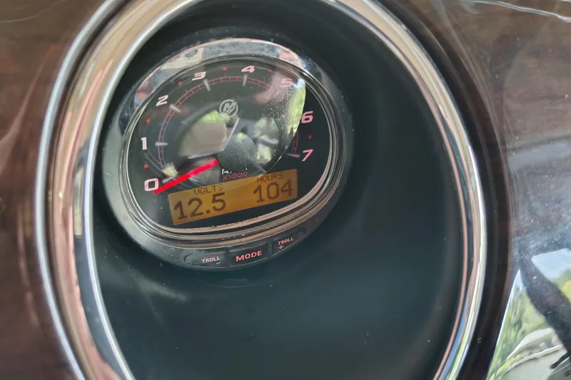 Slide: The Image of Close-up of a 2014 Bennington 2575 QCW I/O boat gauge displaying 12.5 volts and 104 hours. - 45