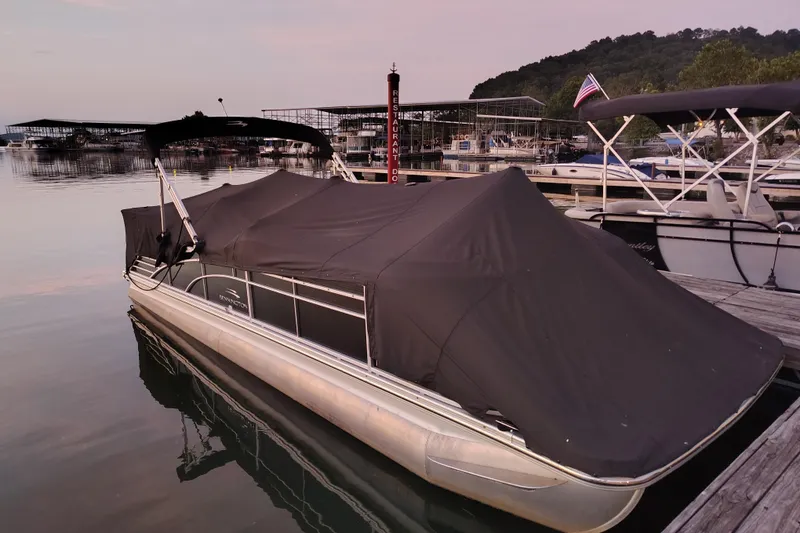 Slide: The Image of 2014 Bennington 2575 QCW I/O pontoon boat docked with cover at marina. - 46