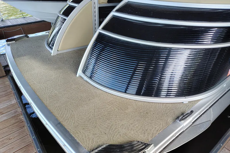 Slide: The Image of 2014 Bennington 2575 QCW I/O boat with sleek black panels and textured flooring. - 50