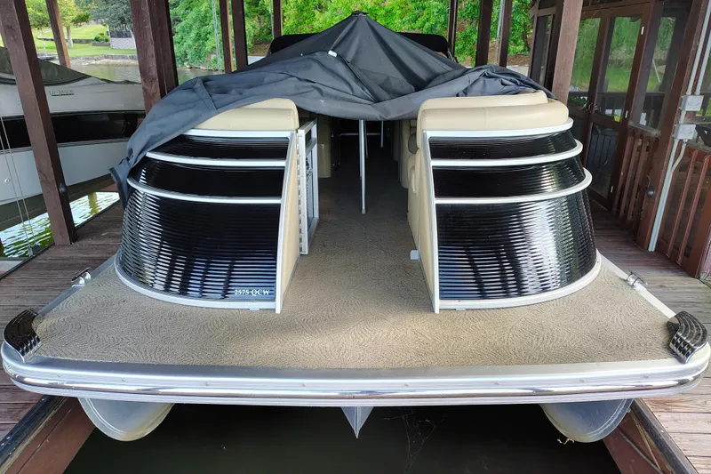 Slide: The Image of 2014 Bennington 2575 QCW I/O pontoon boat docked under cover. - 51