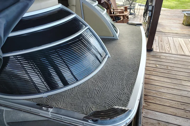 Slide: The Image of 2014 Bennington 2575 QCW I/O boat with textured deck and sleek design. - 52