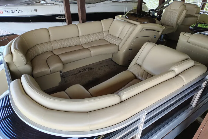 Slide: The Image of 2014 Bennington 2575 QCW I/O boat interior with luxurious beige seating. - 7
