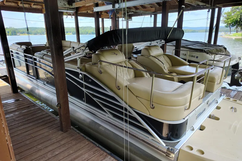 Slide: The Image of 2014 Bennington 2575 QCW I/O pontoon boat docked in a covered marina. - 9