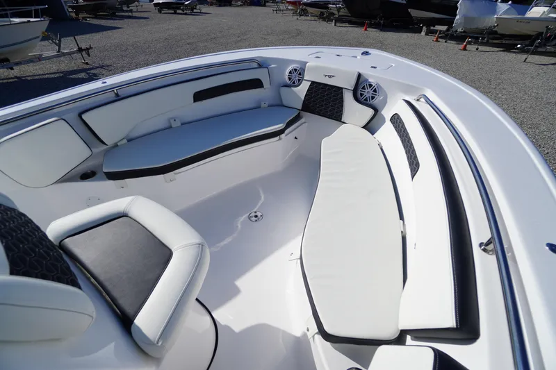 Slide: The Image of 2026 Tidewater 220 LXF boat interior with white seating and black accents. - 11