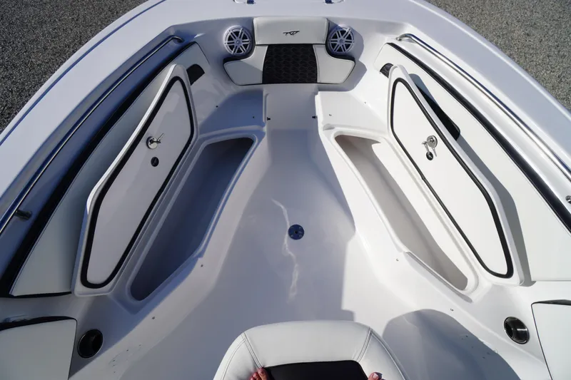 Slide: The Image of 2026 Tidewater 220 LXF boat interior with storage compartments and speakers. - 15