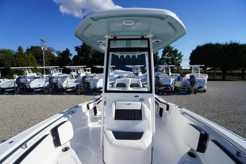 Slide: The Image of 2026 Tidewater 220 LXF boat displayed in a dealership lot under clear blue skies. - 19