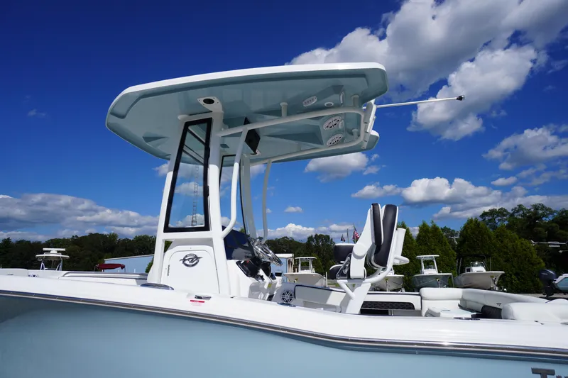 Slide: The Image of 2026 Tidewater 220 LXF boat with T-top against a clear blue sky. - 2