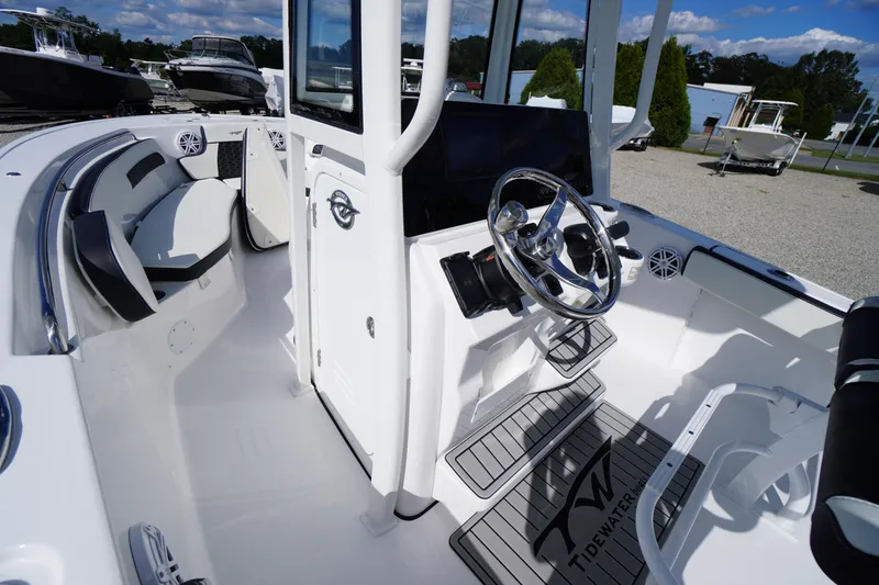 Slide: The Image of 2026 Tidewater 220 LXF boat interior with steering wheel and seating area. - 26