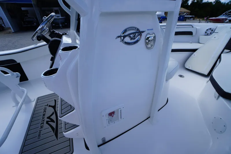 Slide: The Image of 2026 Tidewater 220 LXF boat interior with steering wheel and cup holders. - 34