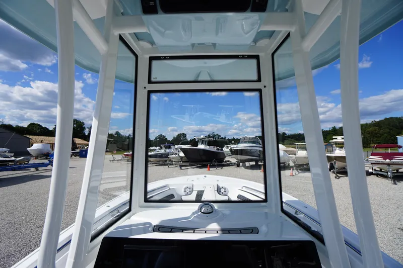 Slide: The Image of 2026 Tidewater 220 LXF boat interior view at a marina under a blue sky. - 40