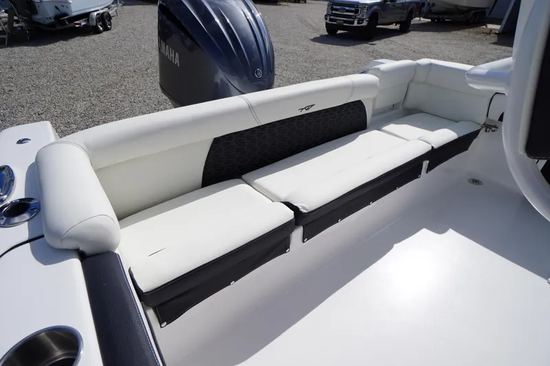 Slide: The Image of 2026 Tidewater 220 LXF boat interior with white cushioned seating and Yamaha engine. - 53