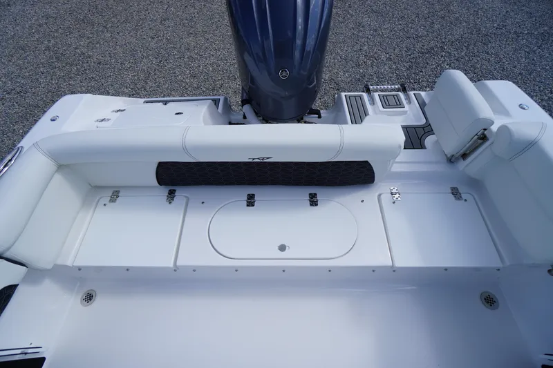 Slide: The Image of 2026 Tidewater 220 LXF boat interior with white seating and storage compartments. - 55