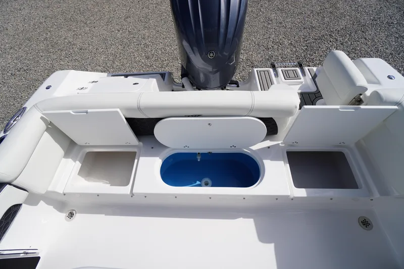 Slide: The Image of 2026 Tidewater 220 LXF boat interior with storage compartments and engine view. - 58
