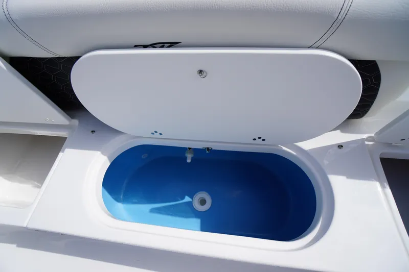 Slide: The Image of Livewell compartment on 2026 Tidewater 220 LXF boat, featuring a blue interior. - 60