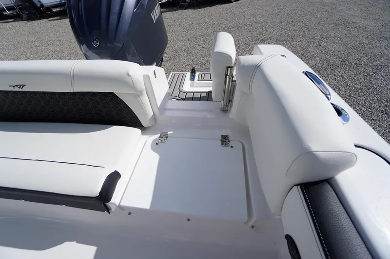 Slide: The Image of 2026 Tidewater 220 LXF boat interior with white seating and Yamaha engine. - 61