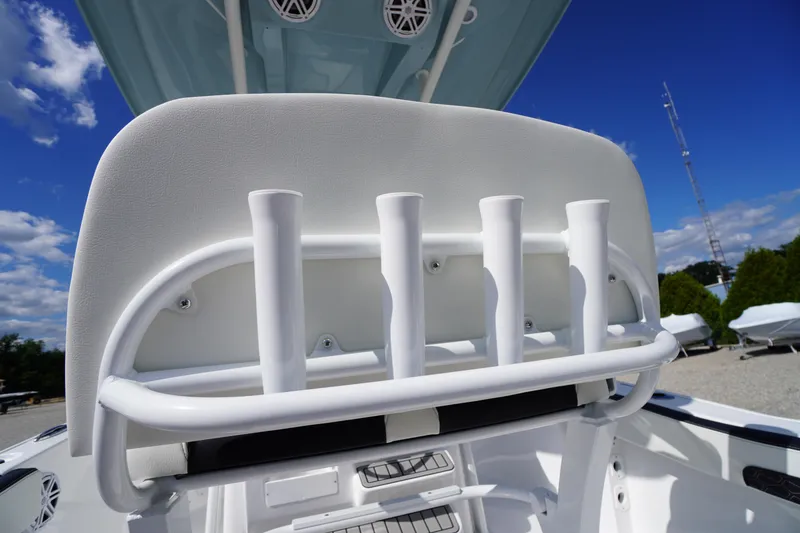 Slide: The Image of 2026 Tidewater 220 LXF boat with rod holders and sleek design under blue sky. - 62