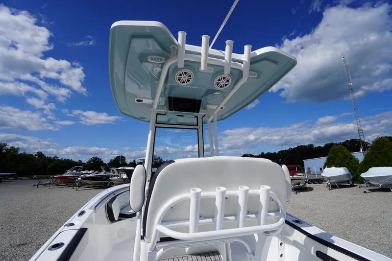 Slide: The Image of 2026 Tidewater 220 LXF boat with T-top and rod holders under a clear blue sky. - 64