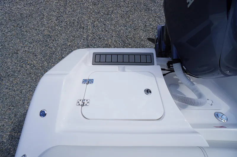 Slide: The Image of 2026 Tidewater 220 LXF boat deck with storage compartment and engine detail. - 71