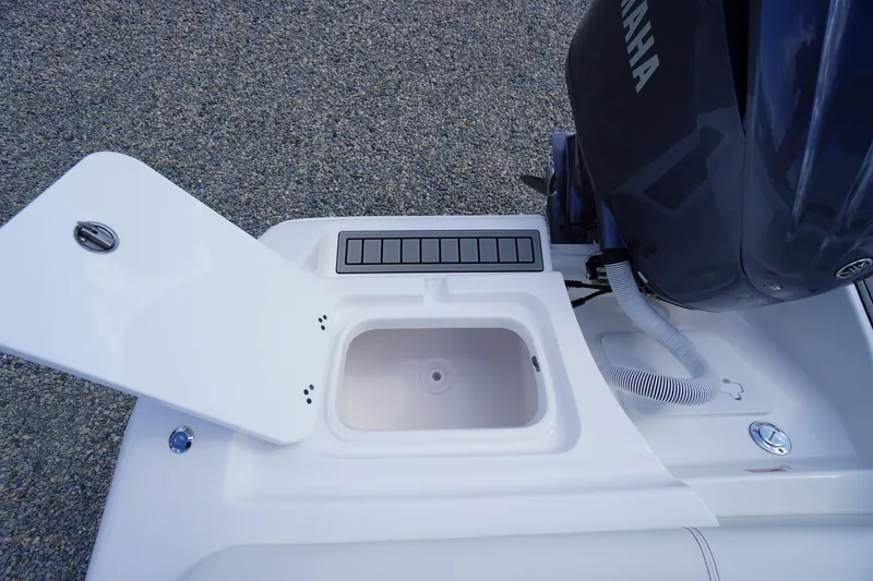 Slide: The Image of 2026 Tidewater 220 LXF boat with Yamaha engine and open storage compartment. - 73