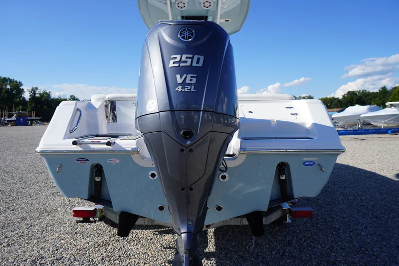 Slide: The Image of 2026 Tidewater 220 LXF boat with Yamaha 250 V6 engine, parked on gravel. - 74