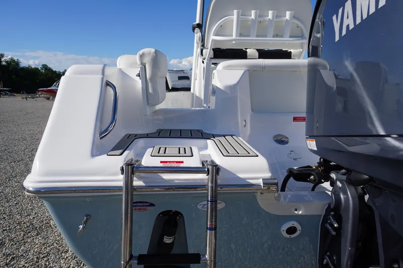 Slide: The Image of 2026 Tidewater 220 LXF boat with Yamaha engine, rear view showing swim platform and ladder. - 76