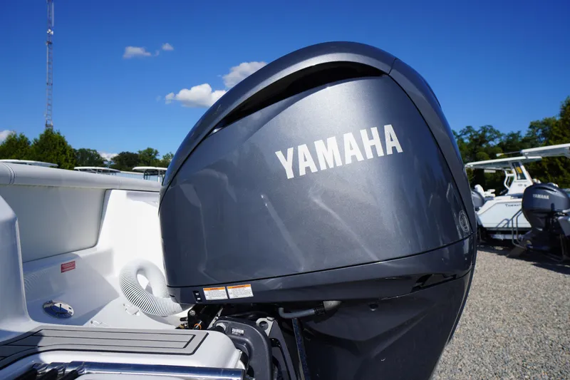 Slide: The Image of 2026 Tidewater 220 LXF boat with Yamaha outboard motor under clear blue sky. - 79
