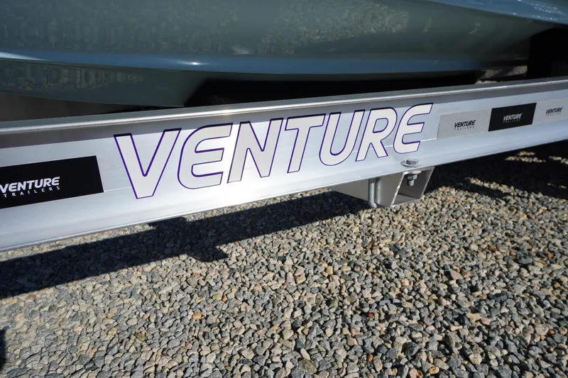 Slide: The Image of Trailer for 2026 Tidewater 220 LXF boat on gravel surface. - 82