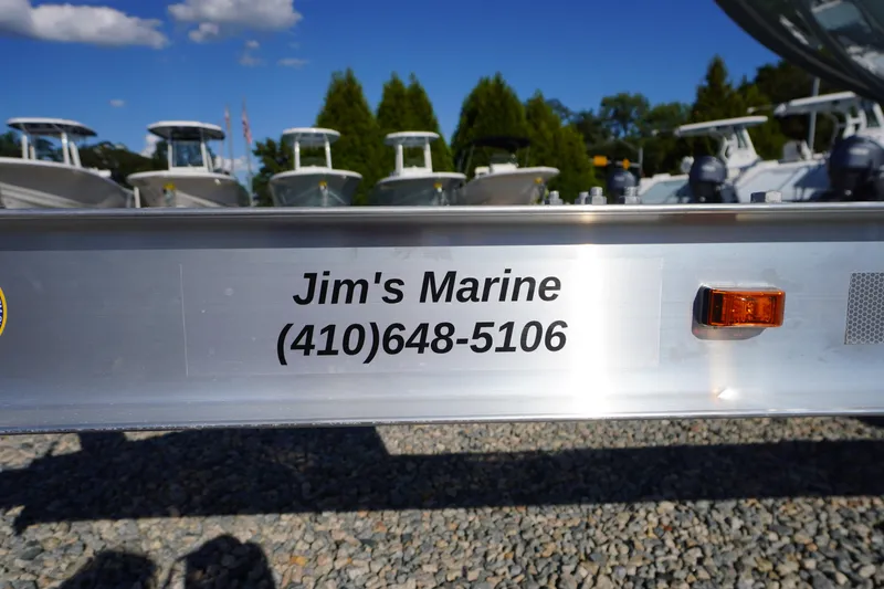 Slide: The Image of Trailer with "Jim's Marine" contact, showcasing 2026 Tidewater 220 LXF boats in background. - 83