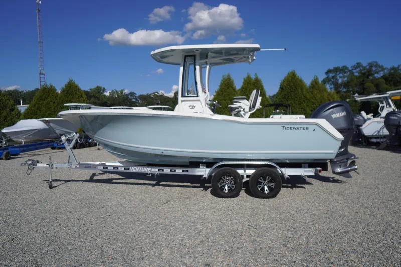 Slide: The Image of 2026 Tidewater 220 LXF boat on trailer, displayed outdoors under clear blue sky. - 85
