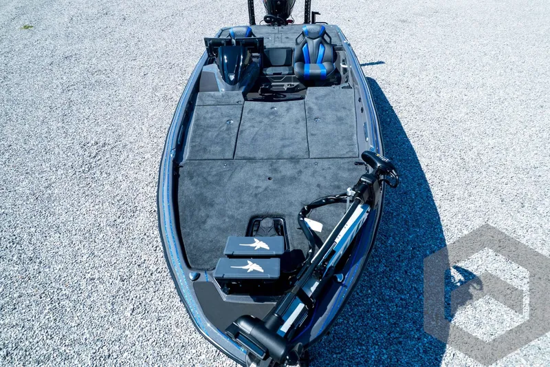 Slide: The Image of 2026 Skeeter FXR21 Apex boat with sleek design and advanced features on gravel surface. - 102